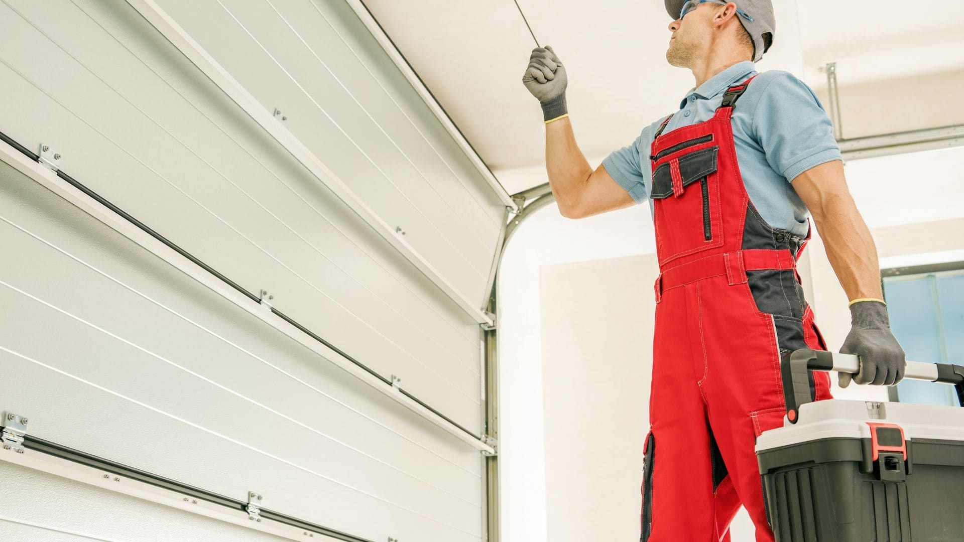 Garage door technician inspecting an overhead door during a service call