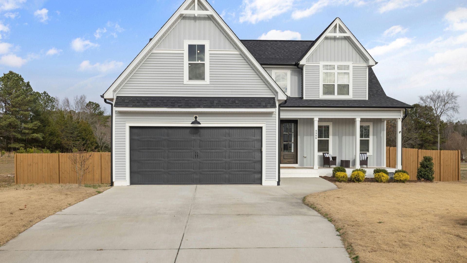 New two-storey home with a freshly installed dark grey garage door